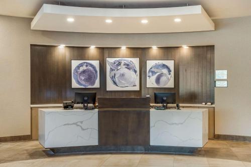 a lobby with three blue and white plates on the wall at Cambria Hotel Fort Mill in Fort Mill