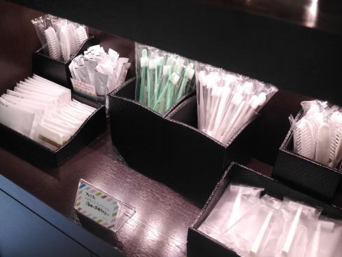 a table with three baskets of napkins and toothbrushes at Centre One Hotel Handa in Handa