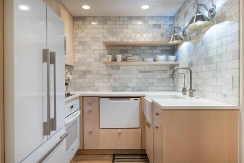 a kitchen with a sink and a dishwasher at Renovated 2 BR Aspen Condo Ski-in out in Aspen