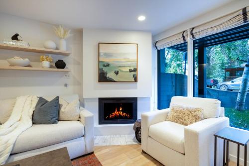 a living room with a couch and a fireplace at Renovated 2 BR Aspen Condo Ski-in out in Aspen