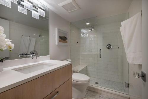 a bathroom with a sink and a toilet and a shower at Renovated 2 BR Aspen Condo Ski-in out in Aspen