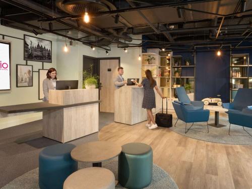 a group of people standing at a reception desk at Adagio Antwerp City Center in Antwerp
