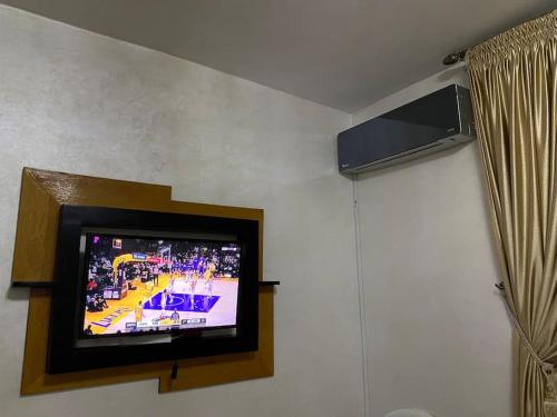 a tv on a wall in a room at Cozy, secure and perfect for family stays in Agadir