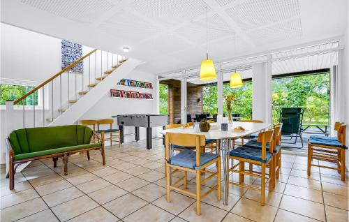 a dining room with a table and chairs at Three-Bedroom Holiday Home In Grenaa in Grenå