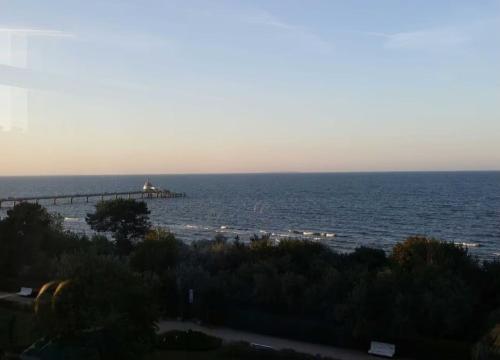 a view of the ocean with a pier in the distance at Ferienhaus Sonnenschein Zinnowitz in Zinnowitz