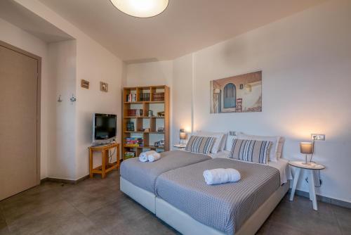 a bedroom with a bed and a television in it at VenMar luxury house in Plataniás