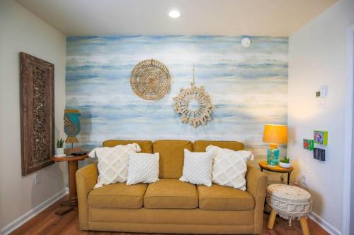a living room with a couch and a painting at Shangri-La in Folly Beach