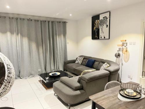 a living room with a couch and a table at Embassy Gardens Royal Suites Apartments in Accra
