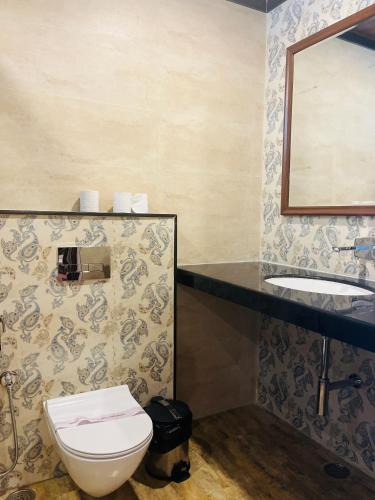 a bathroom with a toilet and a sink at Harnawa Haveli - A Boutique Heritage Stay in Jaipur
