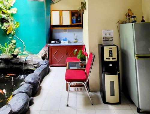 a kitchen with a table and a fish tank at The Homey Rooms and Tours in Yogyakarta