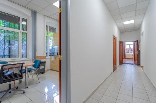 an empty hallway in an office with a table and chairs at Grassalkovich Residence in Budapest