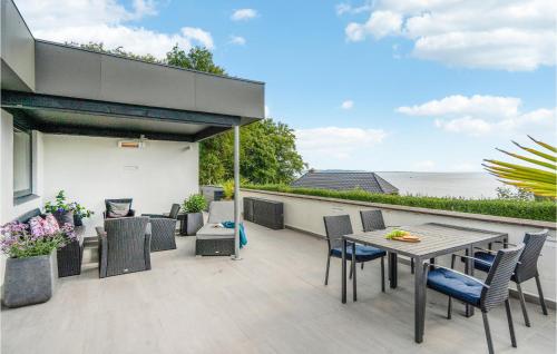an outdoor patio with a table and chairs at 3 Bedroom Lovely Home In Børkop in Børkop