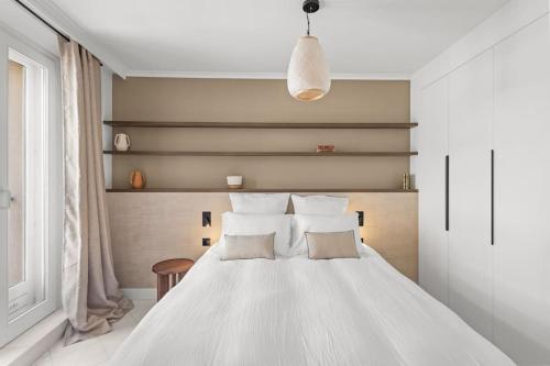 une chambre avec un lit blanc avec deux oreillers dans l'établissement Extraordinaire avec terrasse, à Cannes