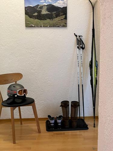 a room with boots and ski poles and a table at Gästehaus Hotel Maria Theresia in Schliersee