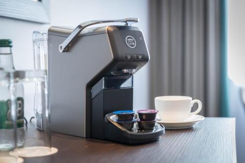 a coffee machine sitting on a table with a cup at Grand Canal Hotel in Dublin