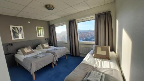 a hospital room with two beds and a window at Hotel Bishops Arms Mora in Mora