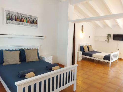 a bedroom with two beds in a room at Vista Mar - Seafront Holiday Apartments in Santa Maria