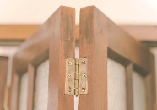 a close up of a wooden door with a latch at Yesterday Hotel in Chiang Mai