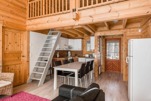 a kitchen and dining room with a loft bed in a tiny house at Yyteri Beach Lomakeskus, Keisarinpankki 1 in Pori