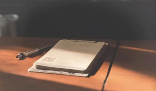 a pen sitting on top of a book on a table at Yesterday Hotel in Chiang Mai