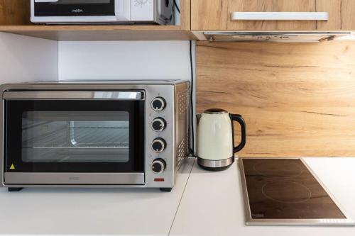 a microwave sitting on a counter next to a toaster oven at Apartmánový dom Štiavnica in Liptovský Ján