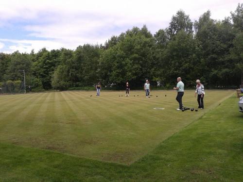a group of people playing a game of dominoes on a field at Hollicarrs - White Rose Lodge in Riccall