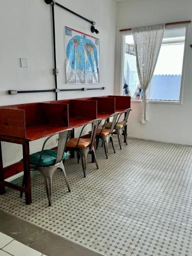 a row of tables and chairs in a room at Albergaria Hostel in Fortaleza