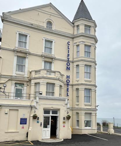 a large white building with a sign on it at Clifton Hotel in Scarborough