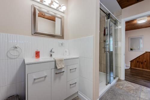 a white bathroom with a sink and a shower at Blue Horizon Sauna Retreat in Lions Head