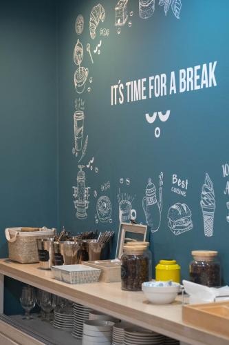 a blue wall with drawings of food on it at U-Sense For You Hostel Sevilla in Seville