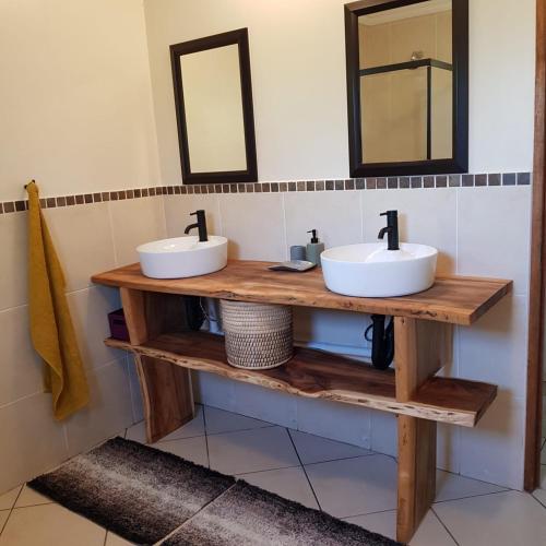 two sinks on a wooden shelf in a bathroom at En-suite, private room, free WIFI in Plett in Plettenberg Bay