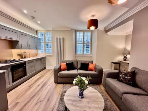 a living room with a couch and a table at Spectacular 2 bed, 2 bath in Edinburgh City Centre in Edinburgh