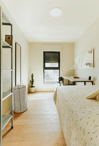 a bedroom with a bed and a desk at Micampus Braga Student Residence in Braga