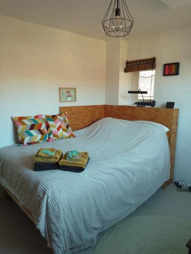 a bedroom with a bed with two towels on it at Kraaipan B&B in Amsterdam