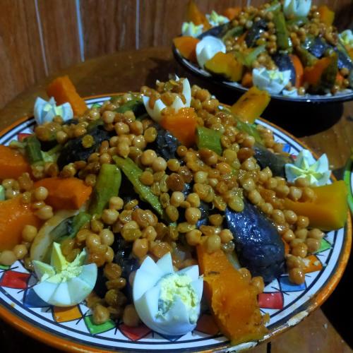 a plate of food with beans and vegetables on a table at Auberge Atlas Toubkal in Imlil