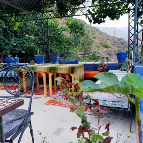 a patio with a table and a couch at Auberge Atlas Toubkal in Imlil
