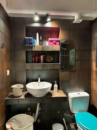 a bathroom with a sink and a toilet at Joanna 2 Apartment with Parking in Larisa