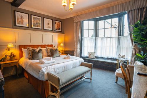 a bedroom with a large bed and a window at Salisbury Arms Hotel in Hertford