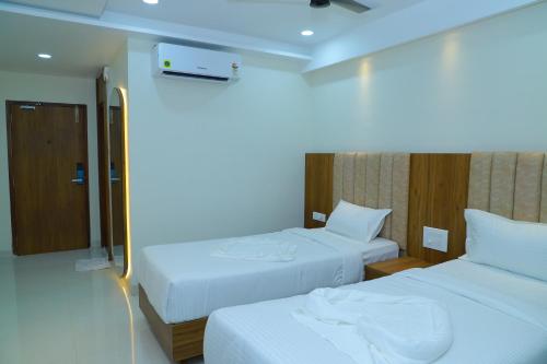 Postel nebo postele na pokoji v ubytování Hotel M Grand