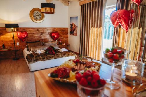 a bedroom with a bed and a table with a tray of food at OSADA LEŚNA - domki z basenem in Stare Miasto