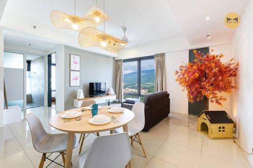 a dining room and living room with a table and chairs at Spacious 3BR in Tropicana 218 at Central Location & Food Hunt Friendly in George Town