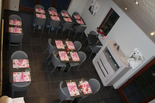 an overhead view of a dining room with tables and chairs at Chanteloup, Maison d'hotes - Halleux in Halleux