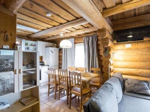 a kitchen and dining room with a couch and a table at Holiday Home Tunturitähti- lainio by Interhome in Ylläsjärvi