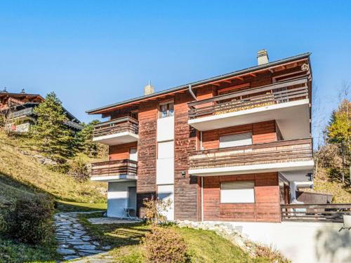 a building with balconies on a hill at Apartment Emeraudes by Interhome in Anzère
