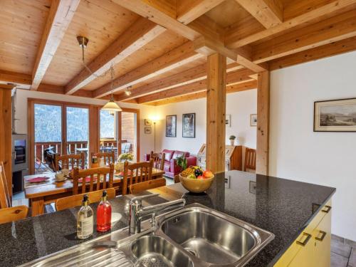 a kitchen and living room with wooden ceilings at Apartment Racer's Retreat Apt-07 by Interhome in Wengen