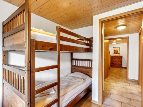 a bunk bed room with two bunk beds in a cabin at Apartment Racer's Retreat Apt-07 by Interhome in Wengen