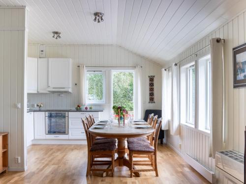 a kitchen and dining room with a table and chairs at Holiday Home Fjordglytt by Interhome in Onarheim