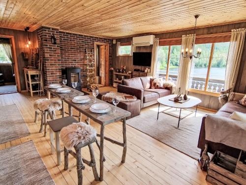 a living room with a table and a brick wall at Holiday Home Staksholmen by Interhome in Konsmo