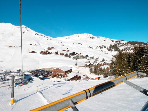 a ski lodge on a snowy mountain with a ski lift at Chalet Godfrey by Interhome in Les Crosets