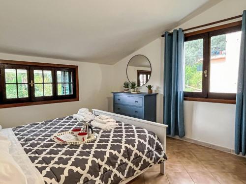 a bedroom with a bed and a dresser and windows at Apartment Asplanato - DOL166 by Interhome in Lecchiore